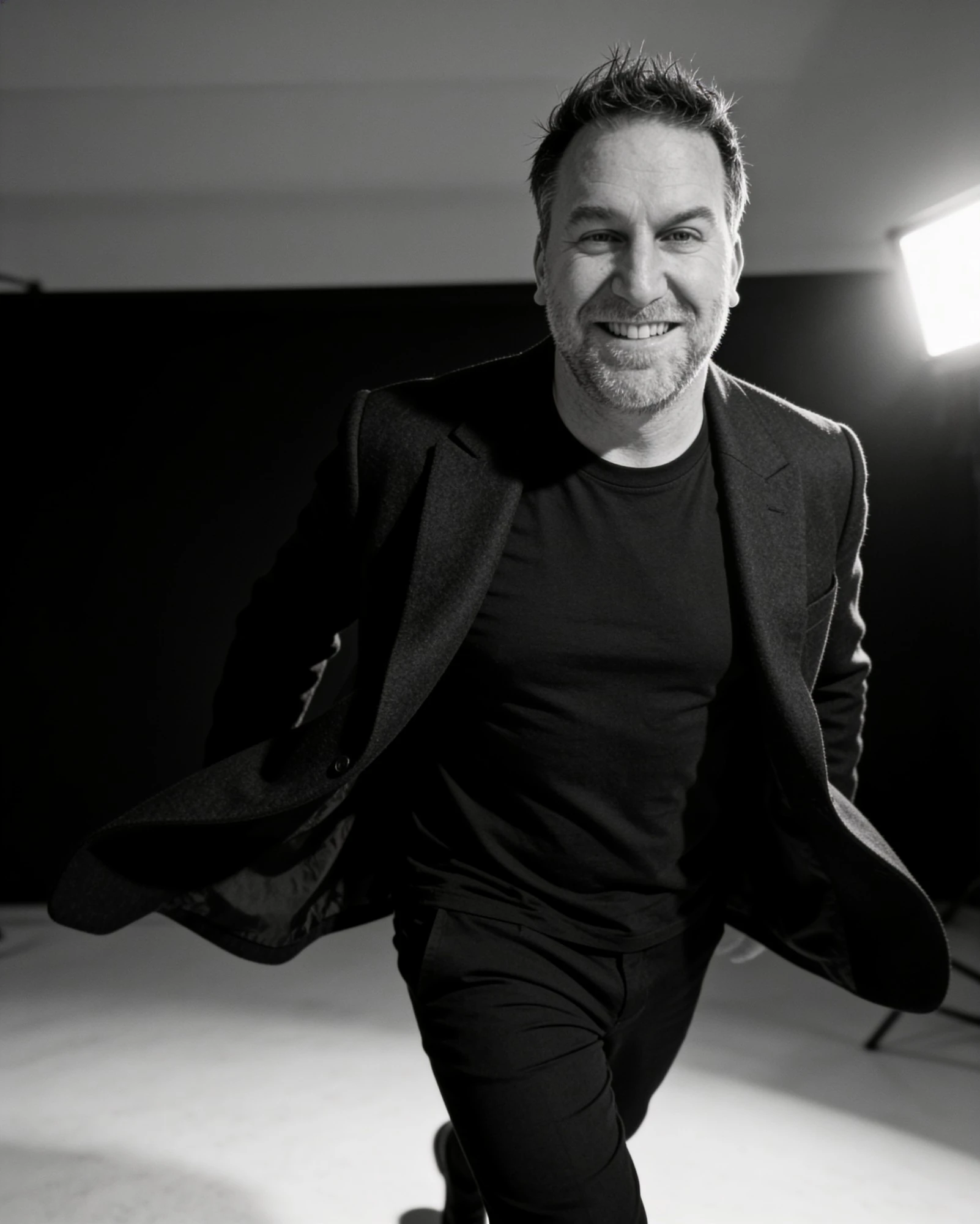 Randy Branam smiling in a monochrome studio portrait