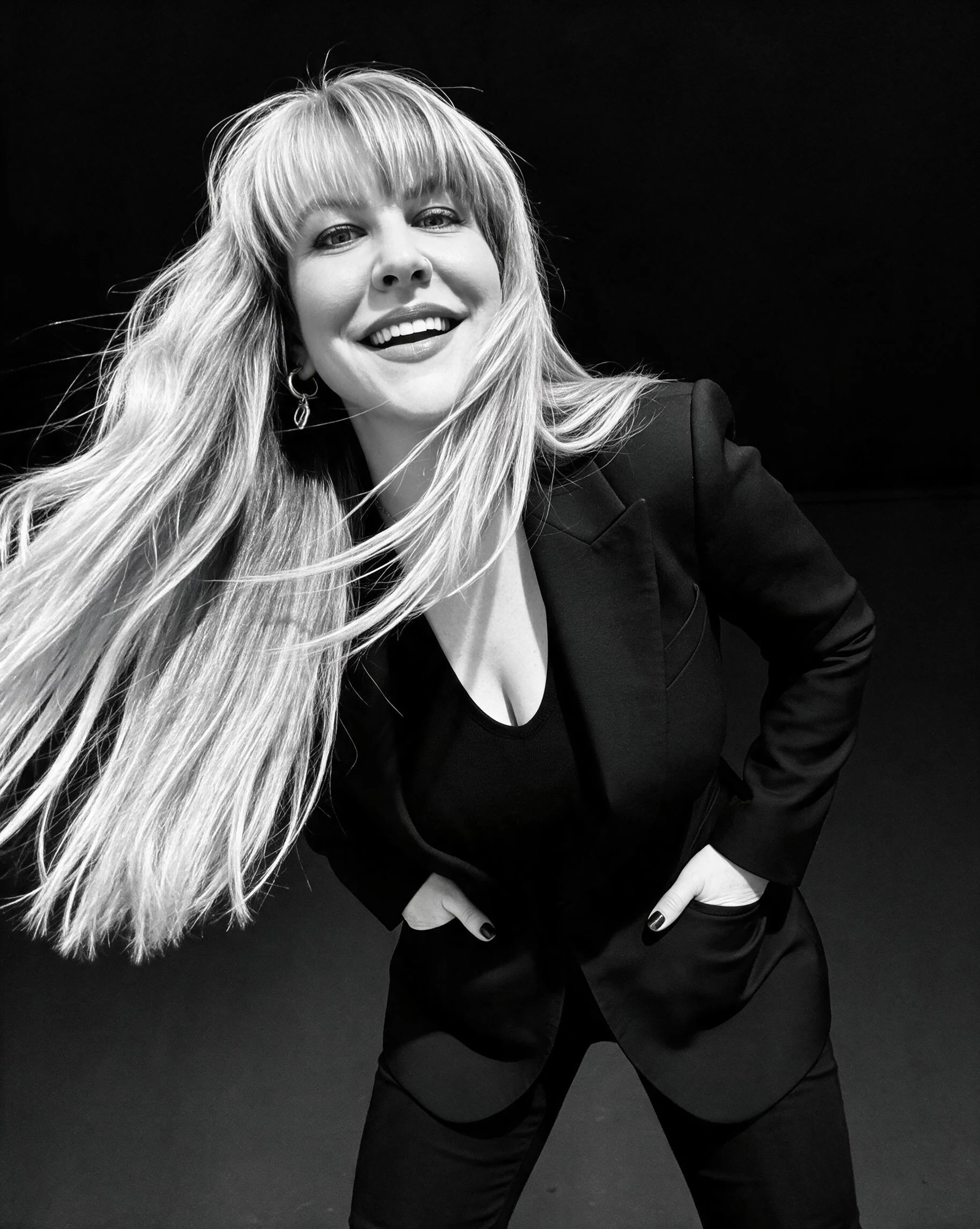 Summer Branam smiling in a monochrome studio portrait