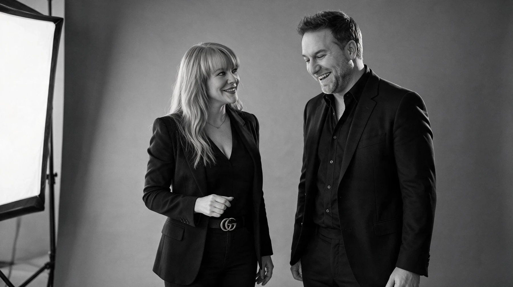 Summer and Randy Branam sharing a laugh in a monochrome studio portrait